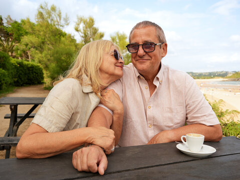 Senior couple enjoy togetherness at beachside cafe