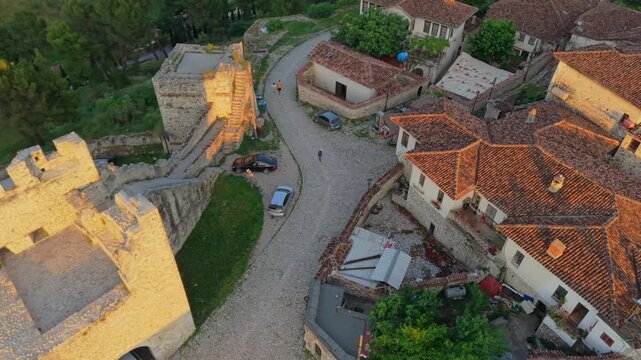 Aerial view of the historic Berat Castle with its ancient stone walls, cobblestone paths, and traditional terracotta rooftops in Berat, Berat County, Albania.