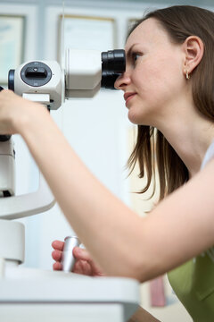 Female ophthalmologist performing eye examination in modern clinic