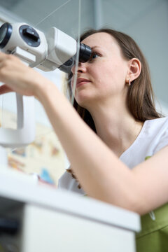 Ophthalmologist perform eye examination with slit lamp microscope