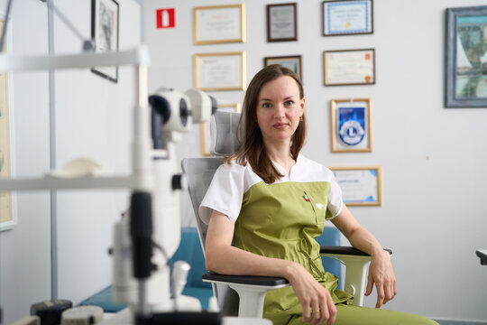 Female ophthalmologist in modern eye clinic examination room