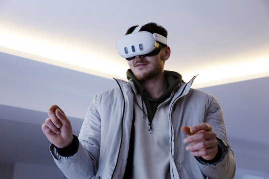 Man using virtual reality headset in modern indoor space