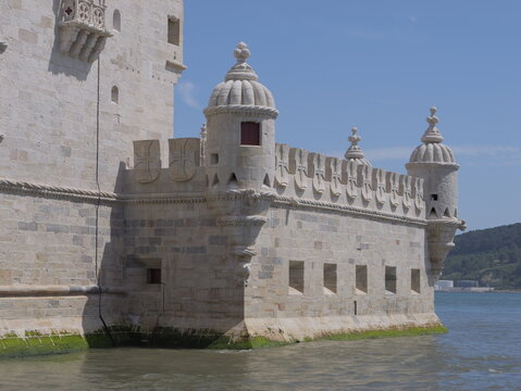 View of the historic Belem Tower with its intricate Manueline stone carvings and defensive turrets situated along the Tagus river in Lisboa, Lisboa, Portugal.