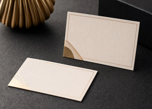 Two elegant blank cream colored place cards with gold foil edge detailing