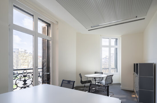 Bright neoclassical office interior with large windows