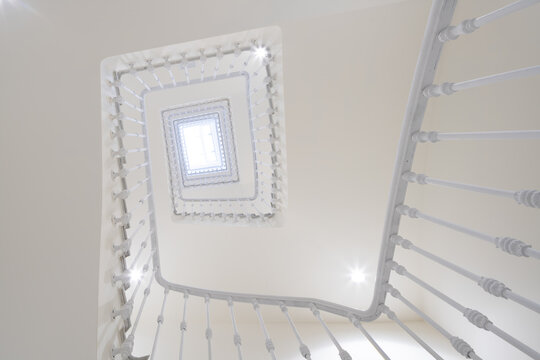 Upward view of neoclassical office building spiral staircase