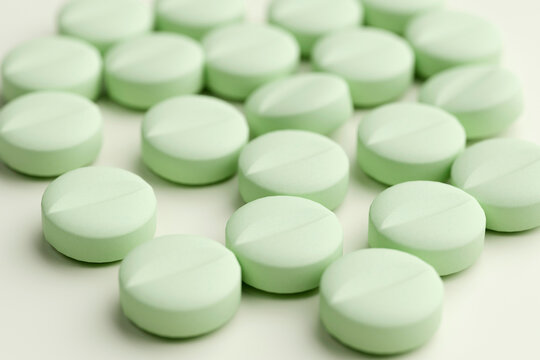 Pale green round tablets with shallow depth of field