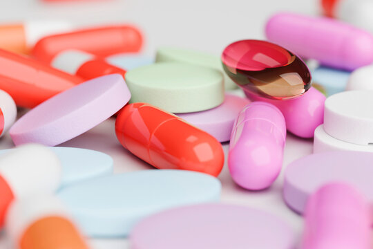 Close-up of colorful pills and capsules on white surface