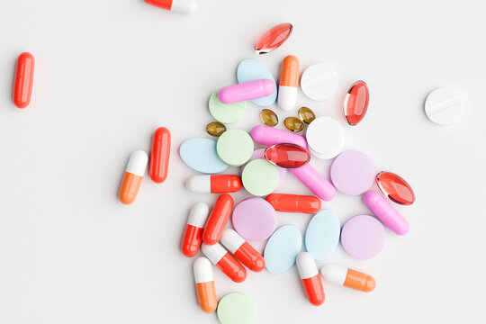 Assorted pills and capsules isolated on white background