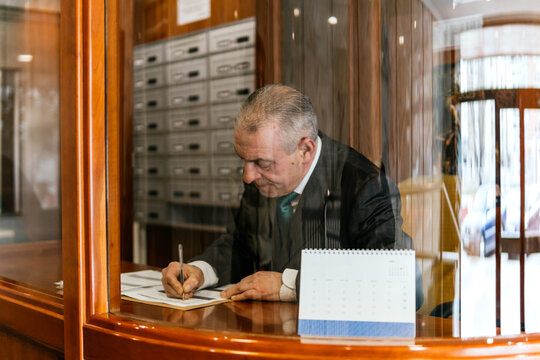 Caretaker at work in old residential building reception
