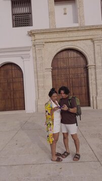 Tourist couple using a smartphone for directions