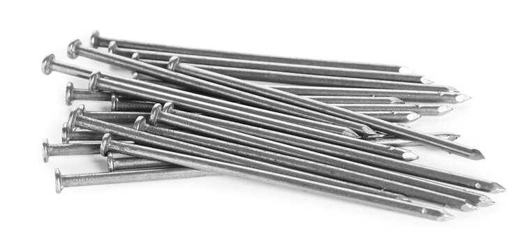 Many shiny metal nails isolated on white