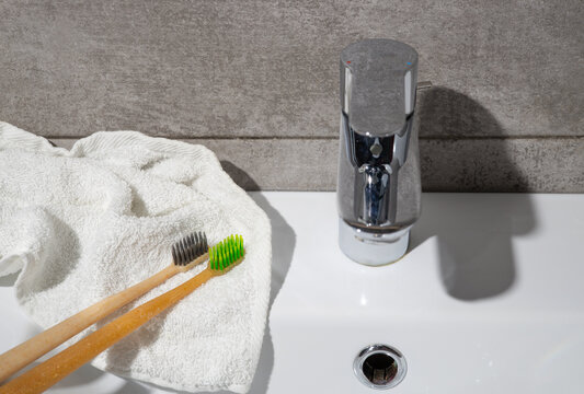Toothbrush and towel by sink for morning dental care