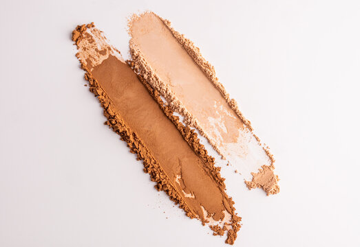 Compact powder swatches with cosmetic texture on white background