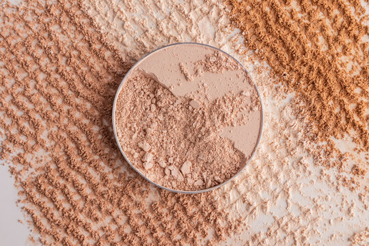 Crushed compact powder swatch with textured cosmetic layout