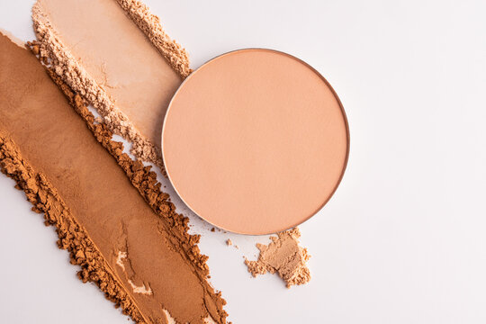 Compact powder makeup swatch with decorative cosmetic smear