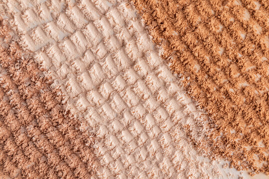 Compact powder swatch with textured cosmetic powder background