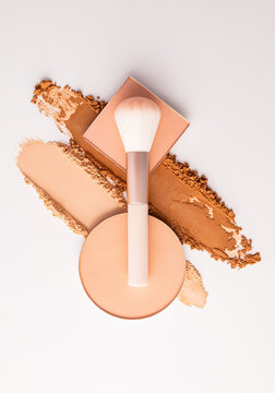 Makeup brush with compact powder and cosmetic swatches