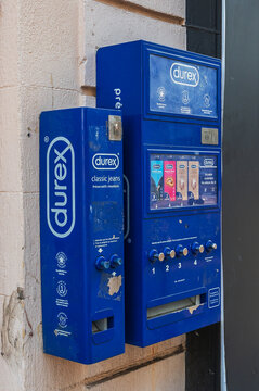 Cannes, France - August 02, 2026: Two blue Durex condom vending machines are mounted on a textured wall