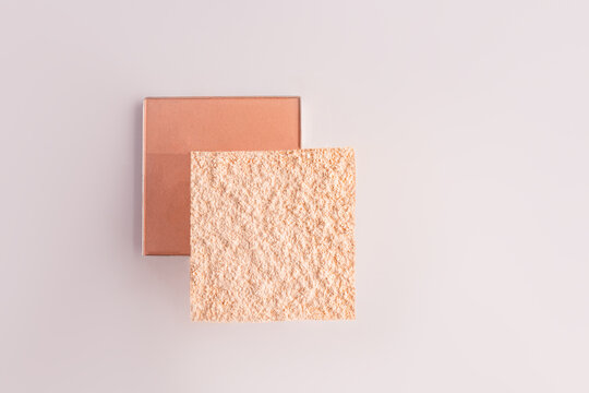 Peach compact powder refill with textured cosmetic swatch
