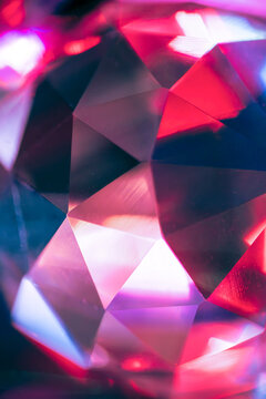 Abstract faceted crystal with vibrant pink and blue light
