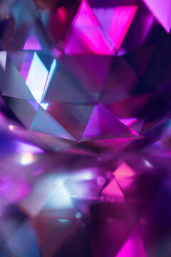 Abstract faceted crystal with neon purple and blue light