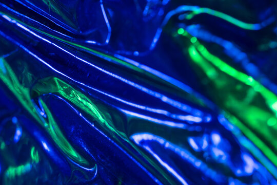 Abstract blue and green iridescent foil texture background