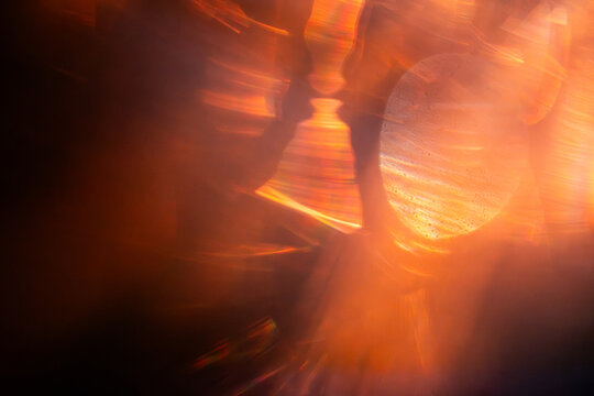 Abstract orange light trails with glowing circular bokeh