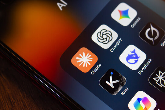Mexico City, MEXICO - Jul 28 2026 : Close-up of an iPhone screen showing an AI app folder with the Claude, ChatGPT, Gemini, DeepSeek, Kimi and other AI chatbot icons over an orange and blue wallpaper.