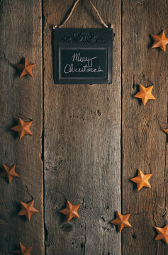 Rustic: Merry Christmas On Chalkboard With Stars To Decorate