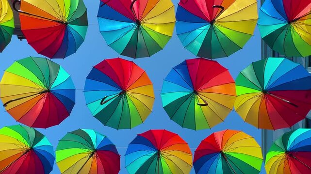 Colorful umbrella canopy viewed from below in Karakoy, Istanbul, bright sky background and dynamic city atmosphere