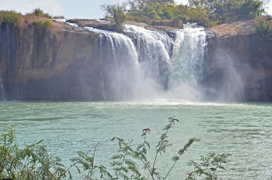 Draysap Waterfall in Vietnam (Dak Lak province) where a wide cascade of water plunges into a calm pool below.