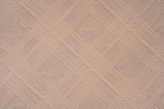Beige paper texture with embossed diagonal geometric pattern