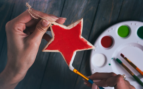 Christmas: Woman Painting Wooden Christmas Ornament Start