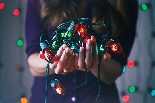 Christmas: Woman Holds Tangle Of Classic Christmas Lights