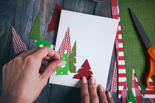 Christmas: Woman Making Homemade Christmas Cards From Various Papers