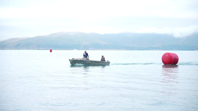 The coastal part of Lake Sevan with its mirror under clear water and beach view of the shore