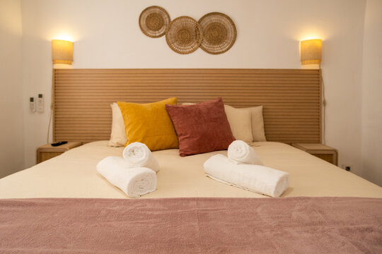 Luxury hotel style bedroom with decorative pillows and towels