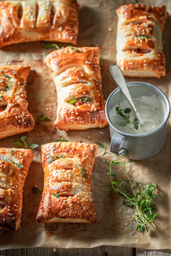 Unique sausage in puff pastry with tatar sauce and herbs.