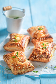 Delicious sausage in puff pastry with tatar sauce and herbs.