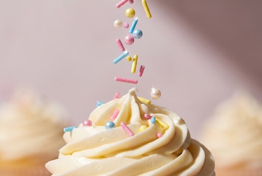 Cupcake Frosting with Pastel Sprinkles and Soft Bakery Styling
