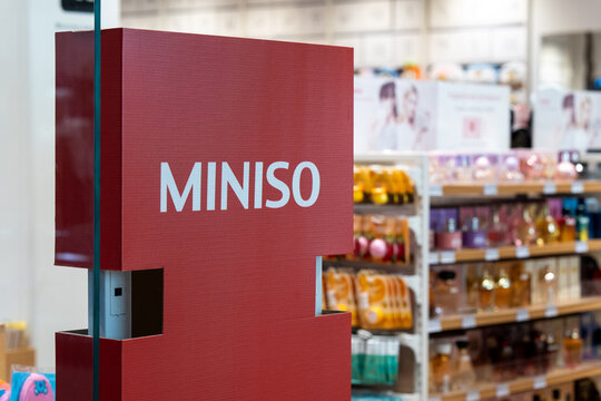 MINISO sign at the entrance to a branded store. The entrance scanners to the Miniso store are decorated with MINISO advertising posters. Minsk, Belarus, March 28, 2025