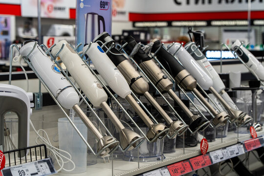 Assorted brands of electric blenders are available at an electronics store. Hand mixers displayed on store shelf. Minsk, Belarus - March 31, 2025