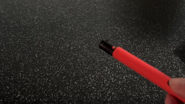 A gas lighter is clicked repeatedly without producing a flame, highlighting ignition attempts and crisp mechanical clicking sounds. High quality FullHD footage