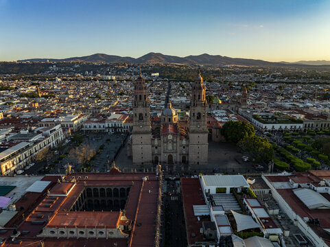 Aerial view of Morelia Cathedral with its twin towers and dome rising above the historic city center, surrounded by colonial rooftops in Morelia, Michoacan, Mexico.