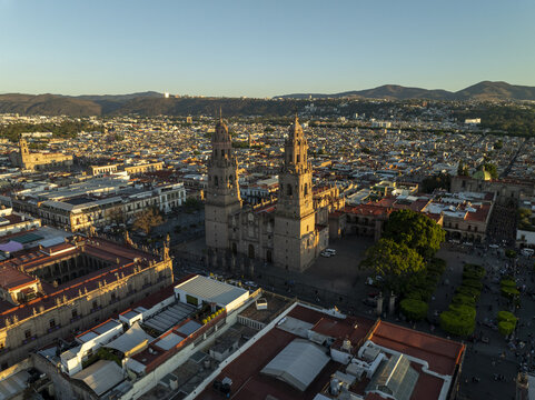 Aerial view of the historic Morelia Cathedral with its iconic twin towers surrounded by colonial rooftops and urban landscape in Morelia, Michoacan, Mexico.