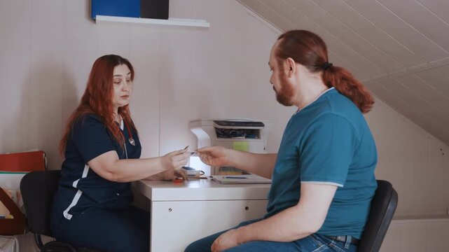 White nurse white patient in home consultation discussing medication and dosage over desk, warm natural light, prescription and notes on table, attentive exchange, patient education and followup