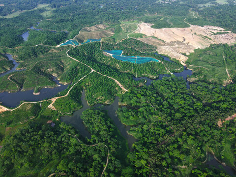 Aerial view of a lush green landscape with winding rivers, reservoirs, and forested hills in Chattogram, Chittagong Division, Bangladesh.