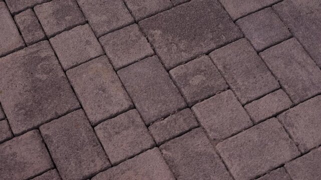 Interlocking concrete paving stones forming geometric walkway pattern
