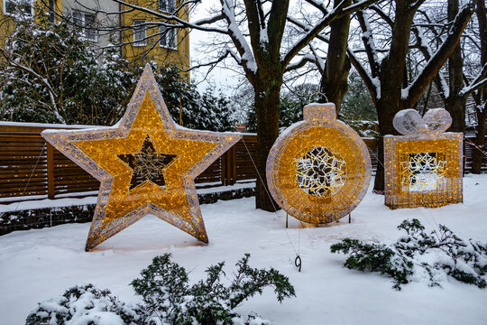 Glowing holiday decorations in snowy yard